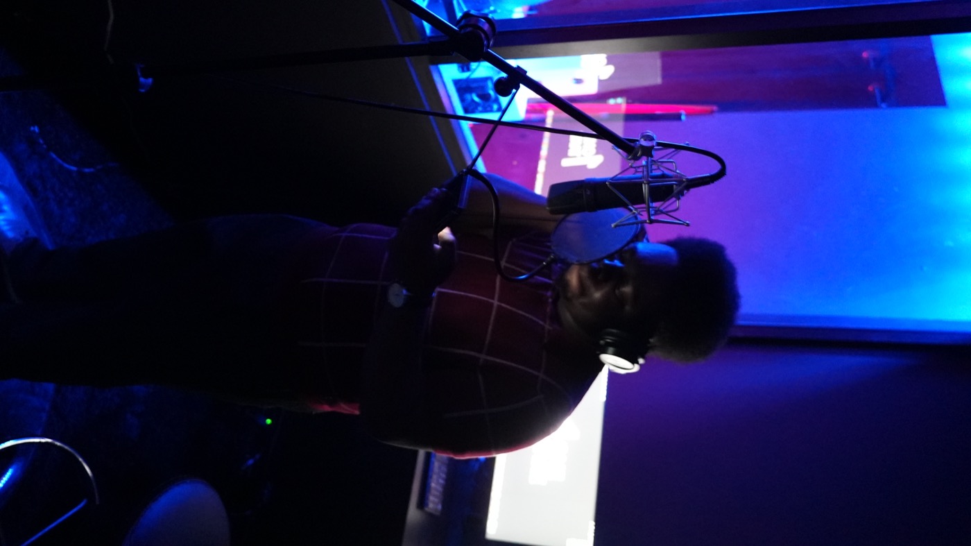 Artist recording vocals at the condenser microphone
